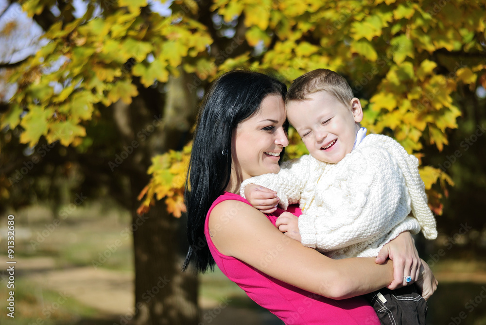 little boy with his mother in autumn park little boy with his mother in autumn park