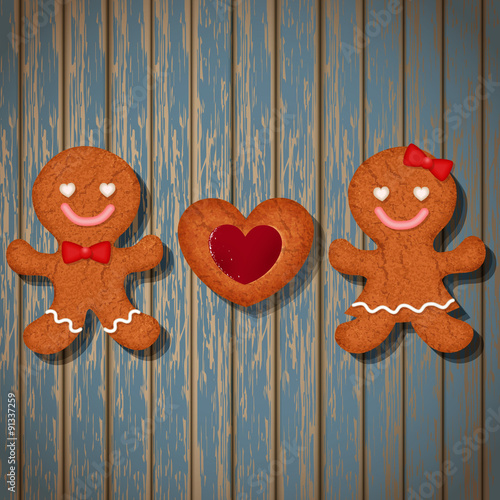 loving couple of gingerbread cookies and strawberry heart cookie