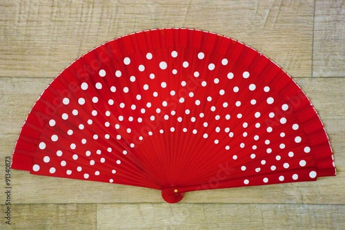 Red opened flamenco fan with white spots