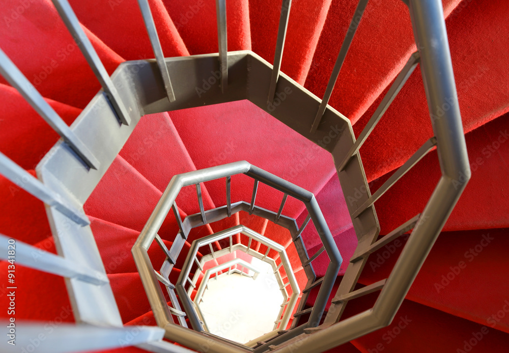 Fototapeta premium modern spiral staircase with red carpet