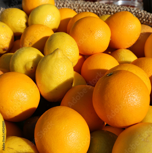 Orange and yellow Sicilian lemons for sale in greengrocers shop