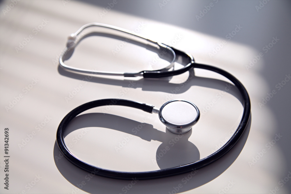 Black stethoscope in blue shade, close up Black stethoscope in blue shade, close up