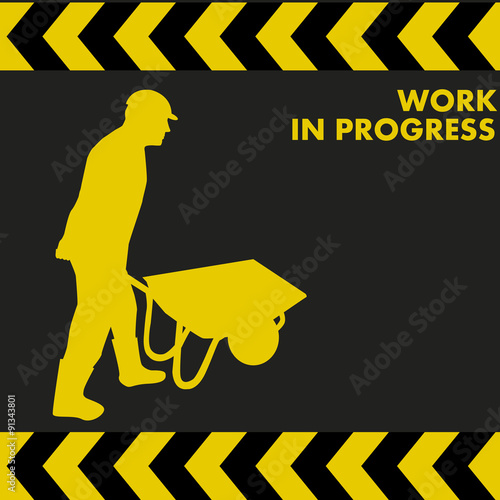 WORK IN PROGRESS sign with worker carries a wheelbarrow