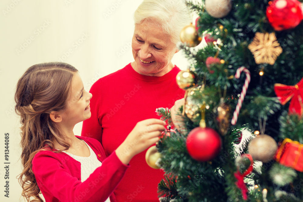 smiling family decorating christmas tree at home smiling family decorating christmas tree at home
