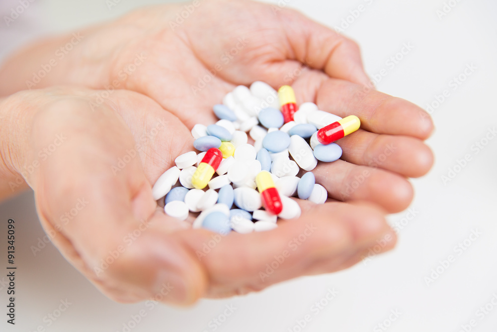 close up of senior woman hands with pills close up of senior woman hands with pills