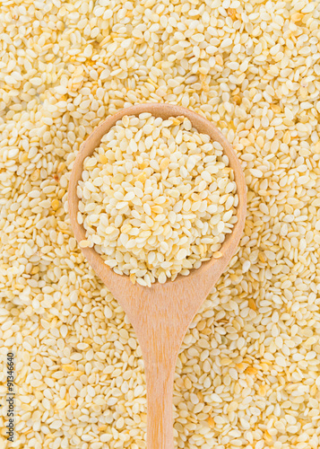 sesame seeds with wooden spoon