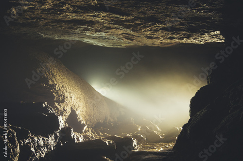 cave entrance with mist and...