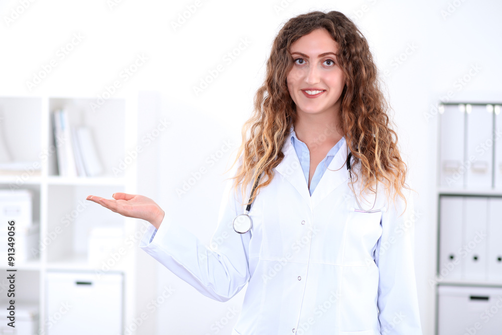 Friendly smiling young female doctor, isolated over white background Friendly smiling young female doctor, isolated over white background