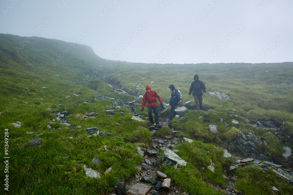 Hikers in raincoats on mountain