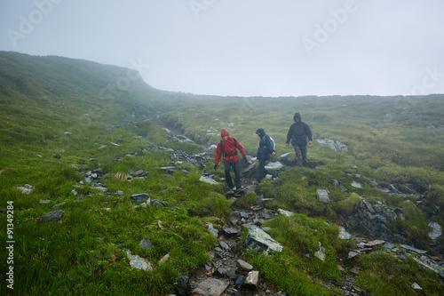 Hikers in raincoats on mountain