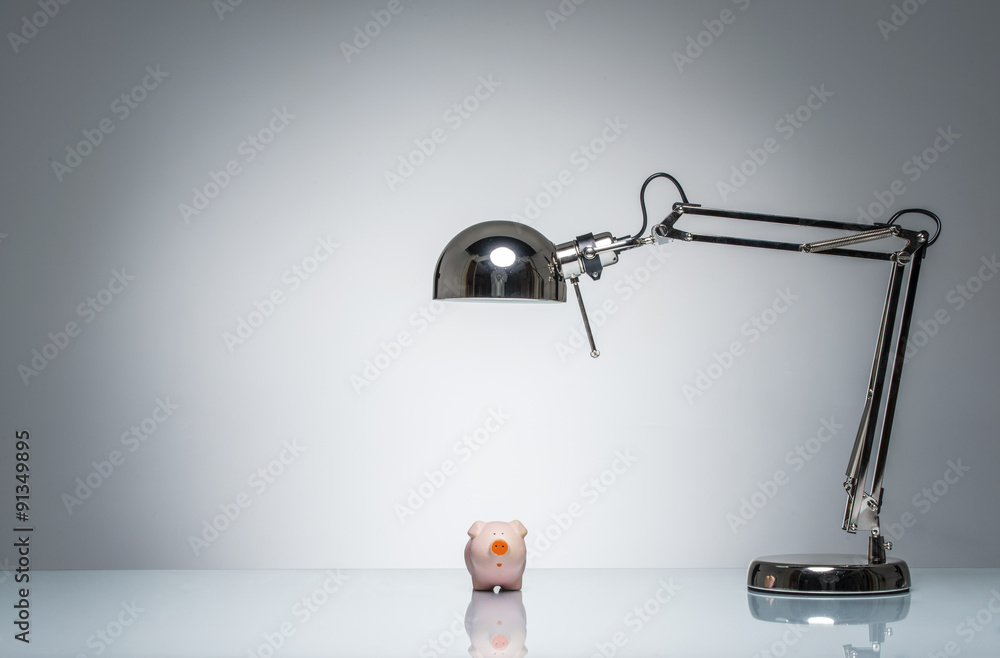 lighting up pink piggy bank with desk lamp lighting up pink piggy bank with desk lamp