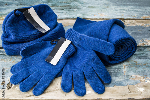 hat, scarf and gloves on a wooden board