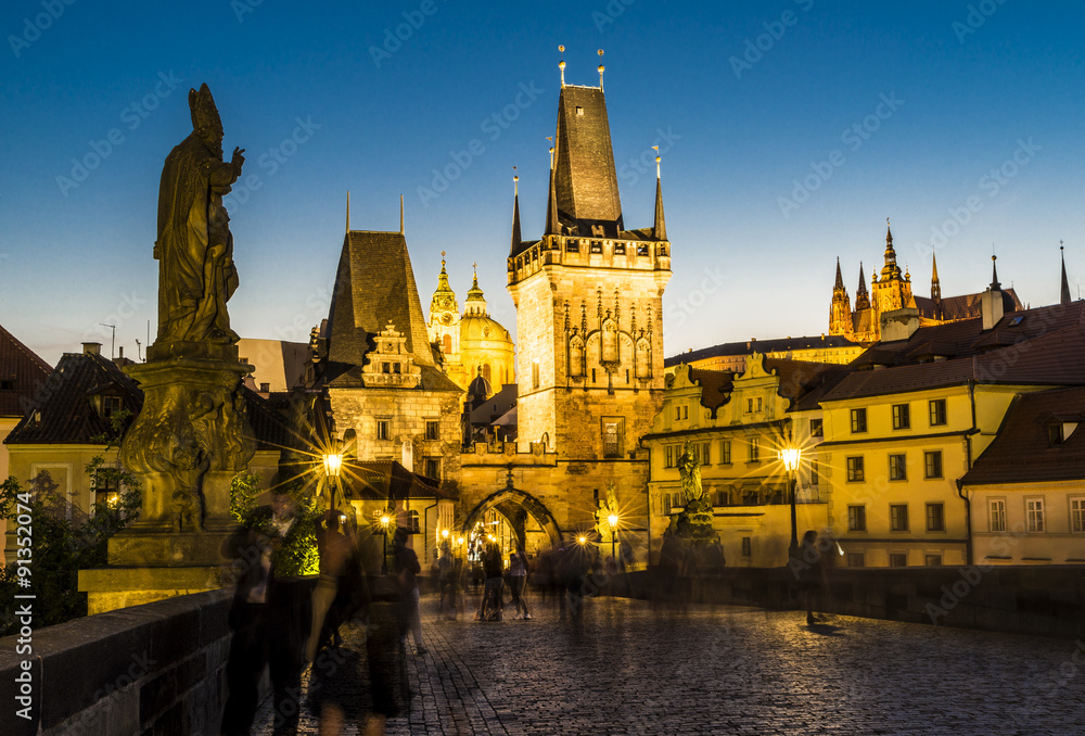 charles bridge with tower and people by night