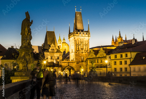 charles bridge with tower and people by night Fototapeta