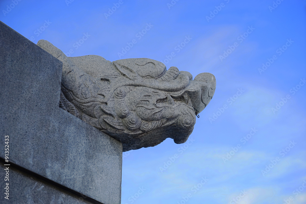 head dragon stone in blue sky