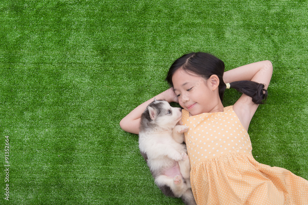 Cute asian girl lying with her puppy Cute asian girl lying with her puppy