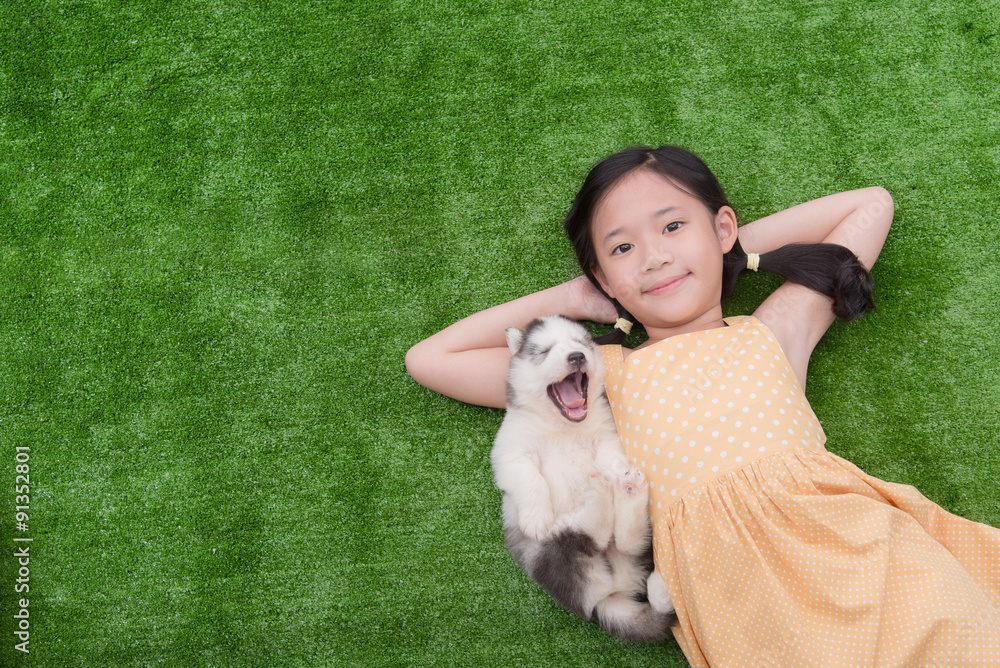 Cute asian girl lying with her puppy Cute asian girl lying with her puppy