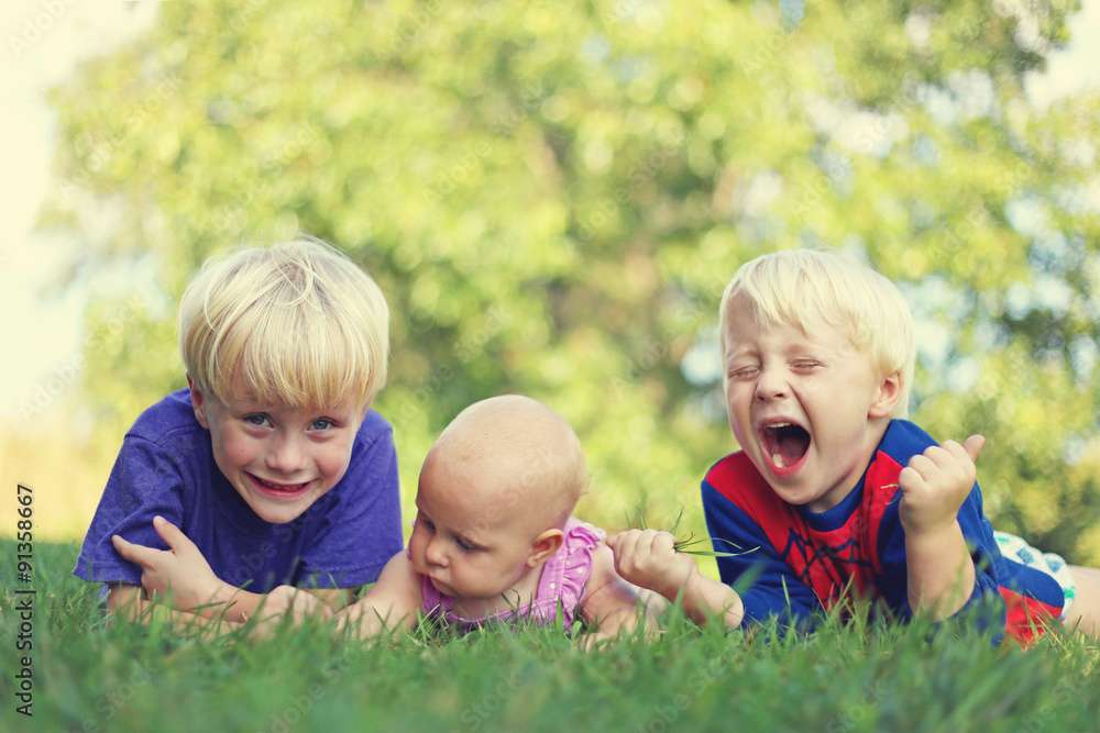 Three silly Children Relaxing Outside Three silly Children Relaxing Outside