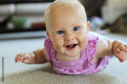 Happy 6 Month old Baby Girl Learning to Crawl photo