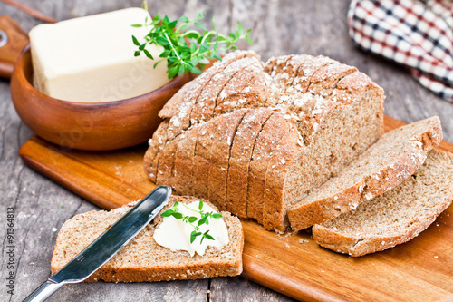 Sliced Irish stoneground soda bread with butter and thyme on the photo