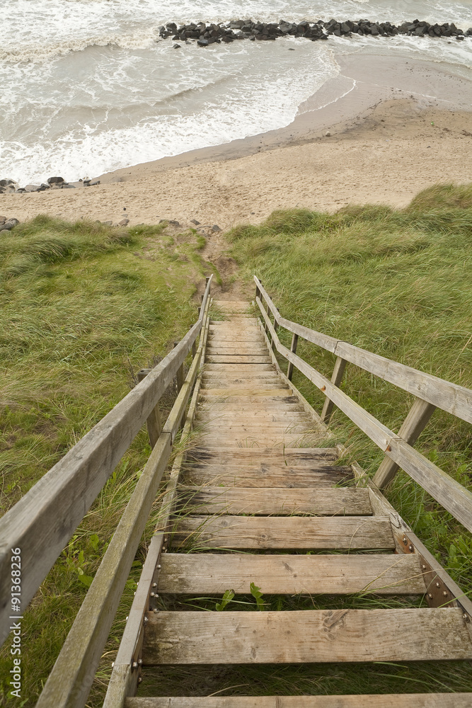 The Stairs Go Down. A steep cliff face can be traversed by a steep set of stairs down to the beach.