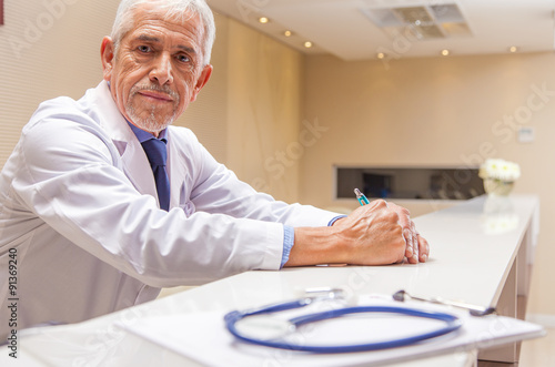 Worried expert male doctor expression with stethoscope in foregr photo