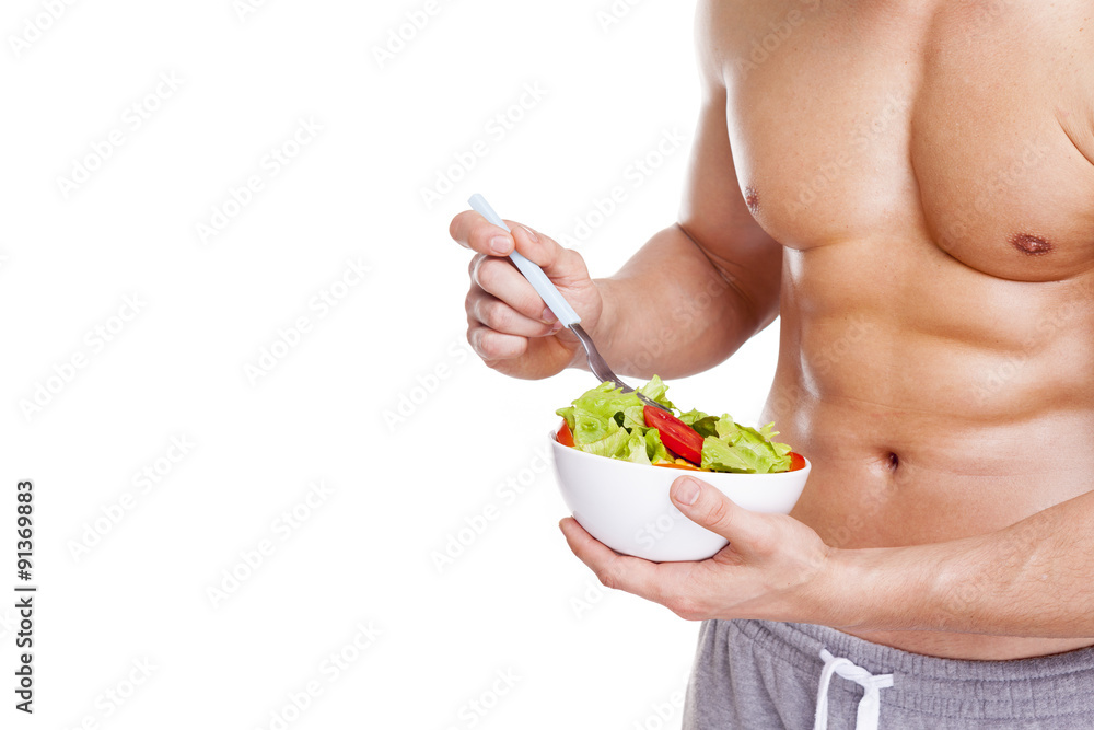 Cropped image of fitness man holding a bowl of salad, isolated o Cropped image of fitness man holding a bowl of salad, isolated o