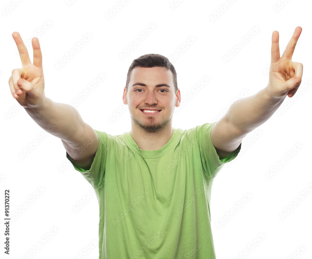 young casual man showing the victory gesture young casual man showing the victory gesture