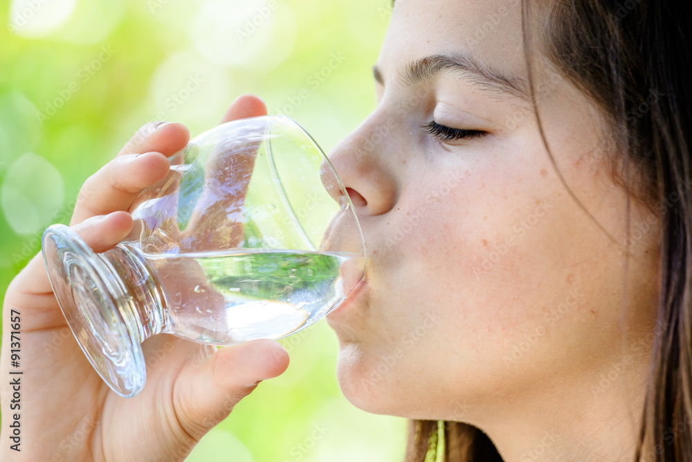 closeup of a healthy young girl drinking glass of water outdoors closeup of a healthy young girl drinking glass of water outdoors
