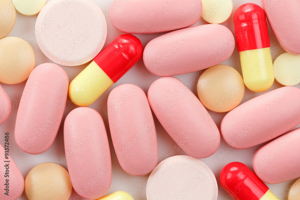 Multicolored Tablets of medicine on white background. Multicolored Tablets of medicine on white background.