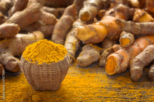 Close up turmeric powder on grunge wooden background. photo