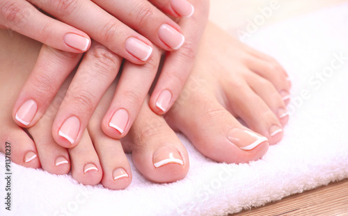 Closeup photo of a beautiful female feet with red pedicure
