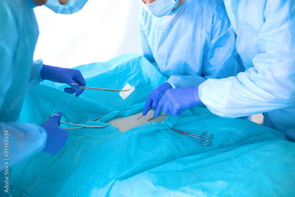 A team of surgeons at work in the operating room A team of surgeons at work in the operating room