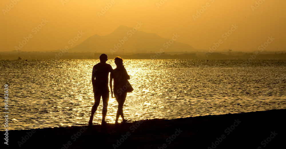 romantic stroll along the beach at sunset couple