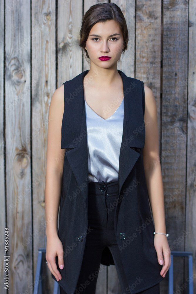 fashionable girl in a blouse stands on the street fashionable girl in a blouse stands on the street