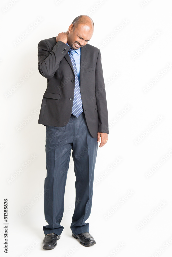 Full length mature Indian businessman shoulder pain Full length mature Indian businessman shoulder pain