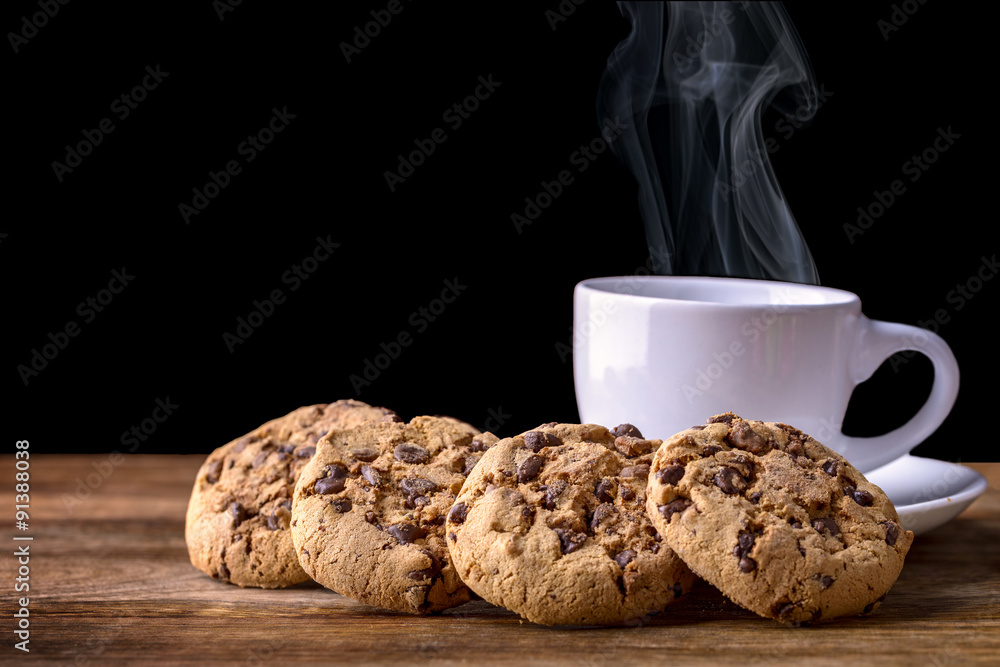 steaming cup of coffee with chocolate cookies on wood - obrazy, fototapety, plakaty 