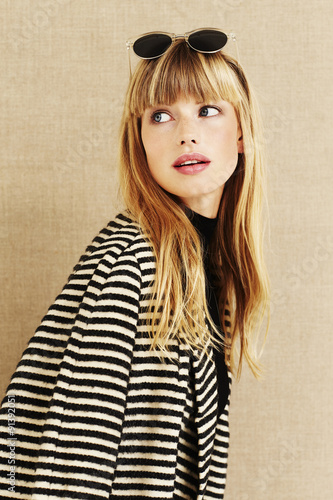 Business woman in striped coat looking over shoulder