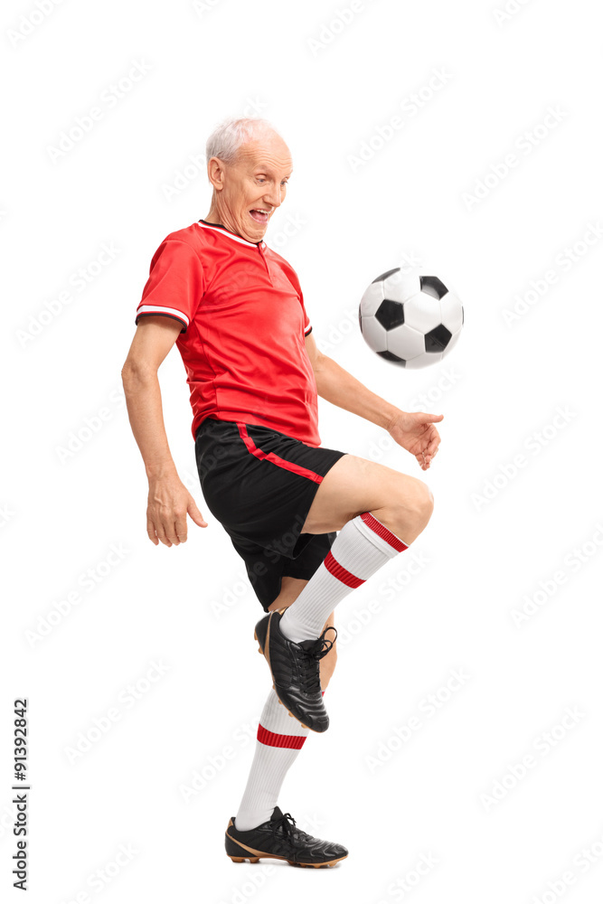 Joyful senior juggling a football and smiling Joyful senior juggling a football and smiling