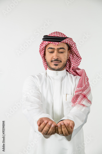 Arab man with hands cupped. photo