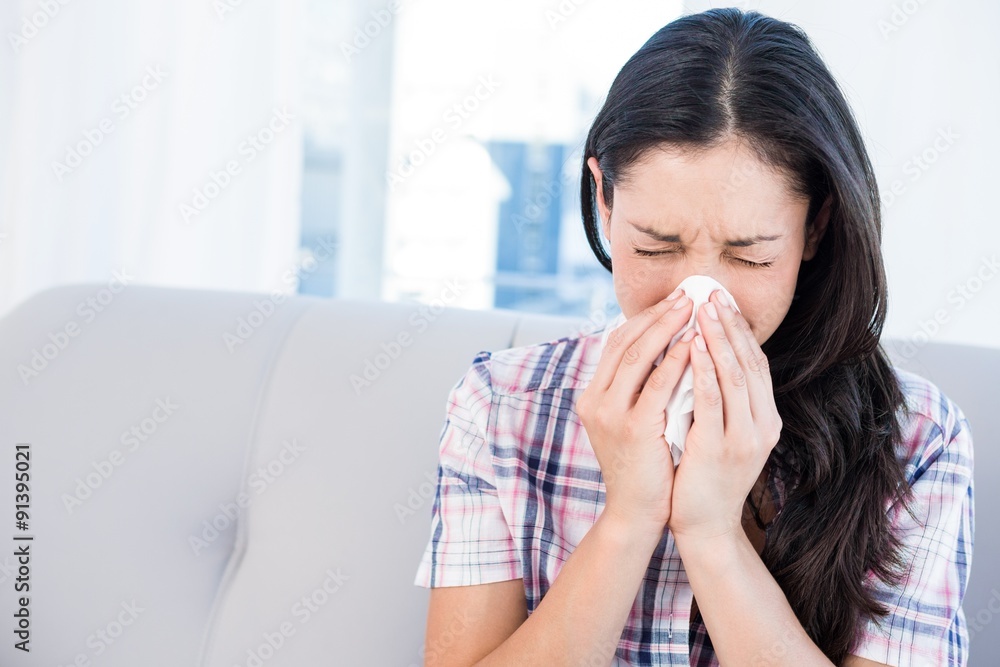 Pretty brunette sneezing in the living-room Pretty brunette sneezing in the living-room