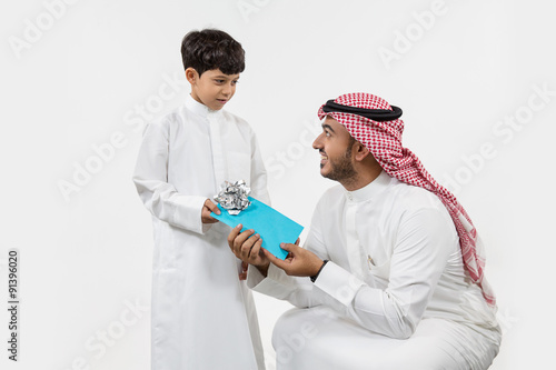 Father giving gift to his son. photo