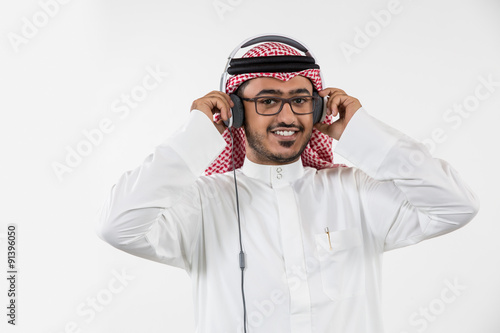 Portrait of Arab man listening music on headphones photo