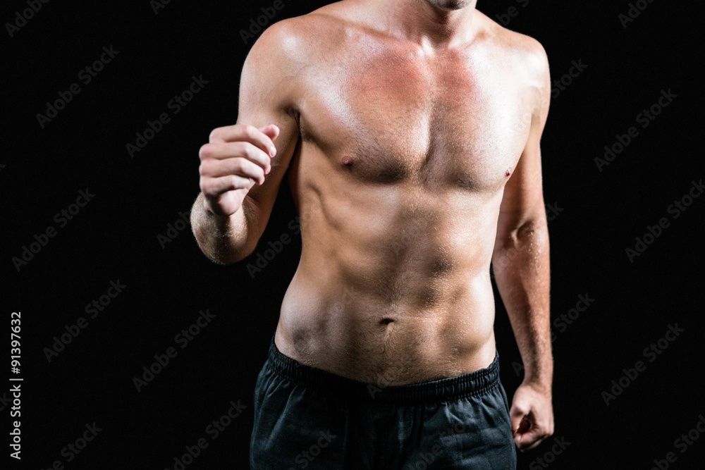 Midsection of shirtless athlete running Midsection of shirtless athlete running