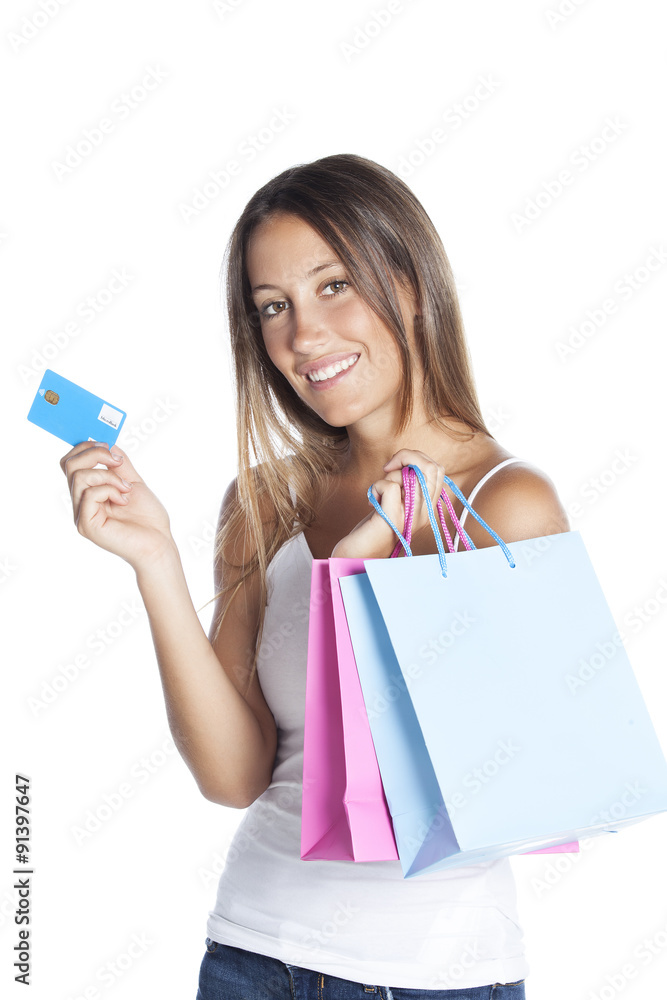 Young woman with shopping bags and credit card on a white background Young woman with shopping bags and credit card on a white background