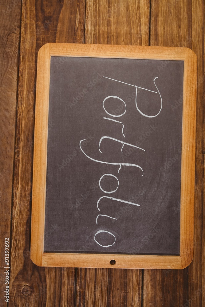 Chalkboard on table with portfolio text Chalkboard on table with portfolio text