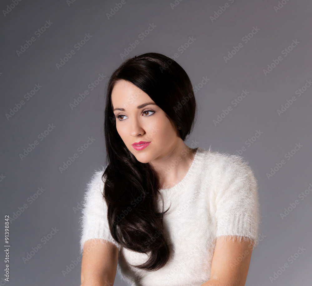 portrait of pretty brunette woman in white sweater. portrait of pretty brunette woman in white sweater.