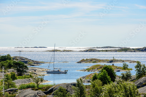 Photography Moored sailboat and skerries in the sun