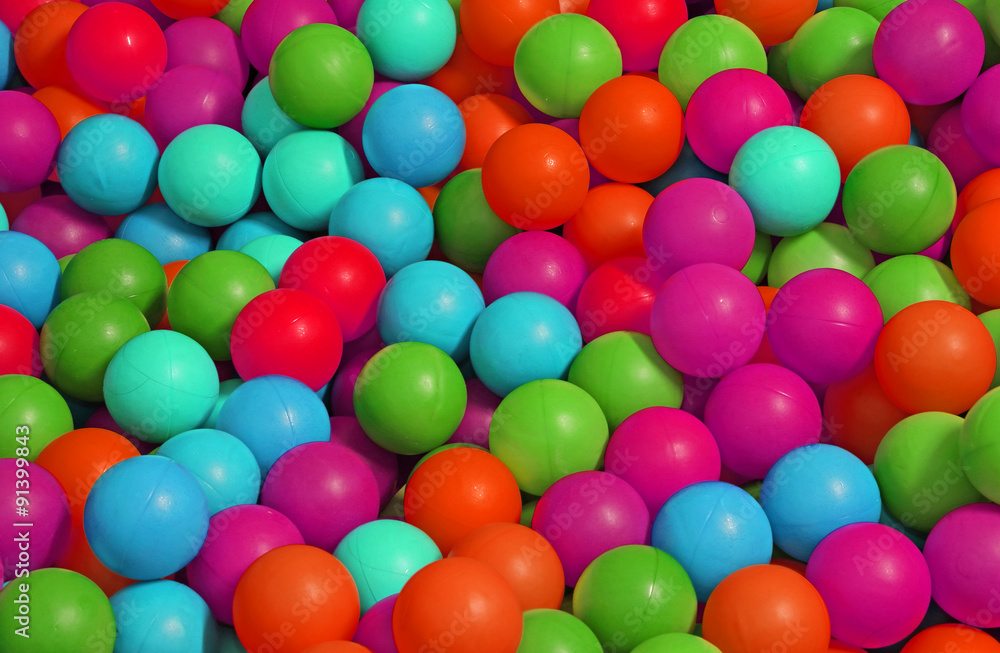 background of many colored plastic balls in a pool background of many colored plastic balls in a pool