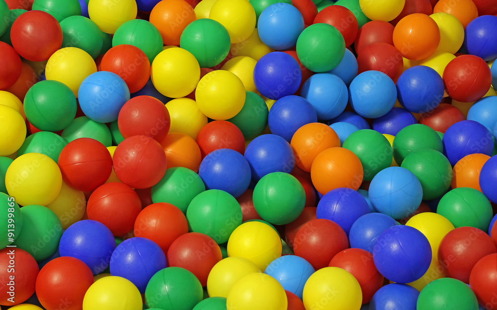 background of many colored plastic balls in a pool background of many colored plastic balls in a pool